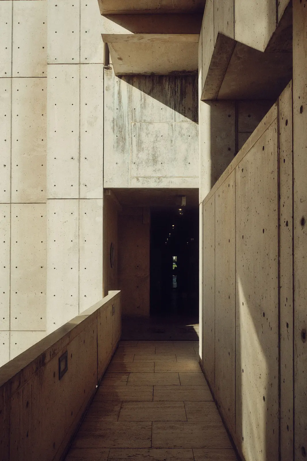 Brutalist covered walkway in board-marked concrete