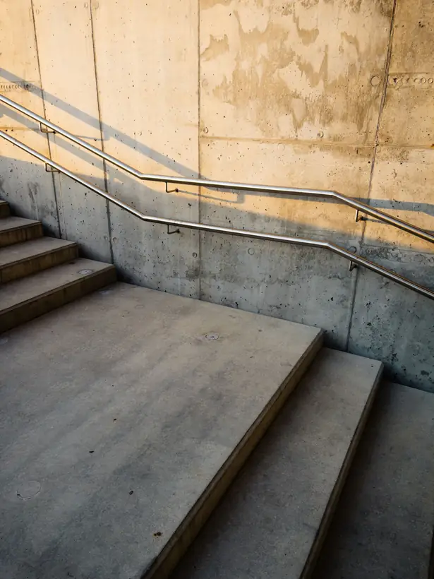 Concrete stair cut by long diagonal shadows