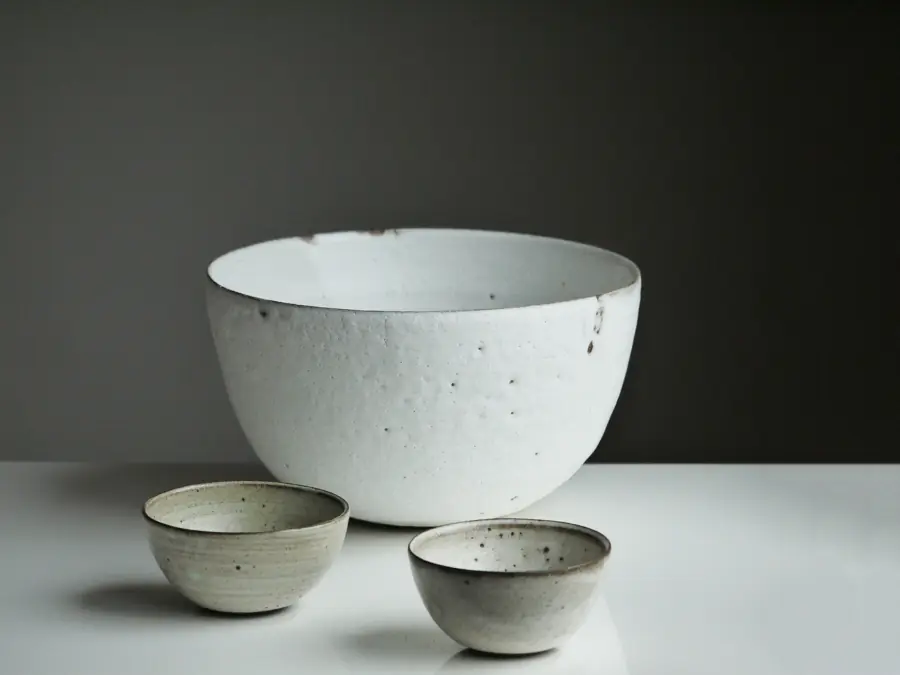 White stoneware bowl on a pale surface
